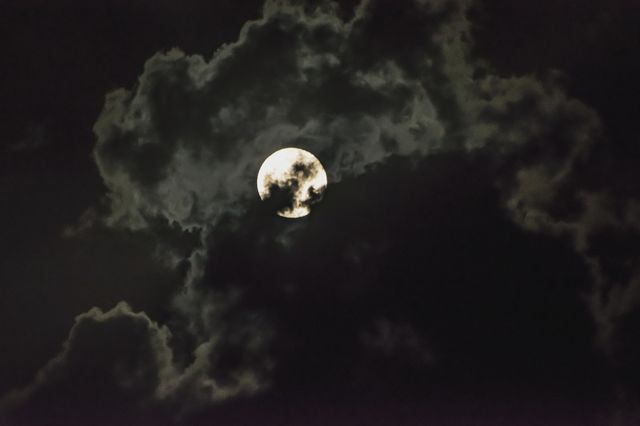 Moon in cloudy sky during night
