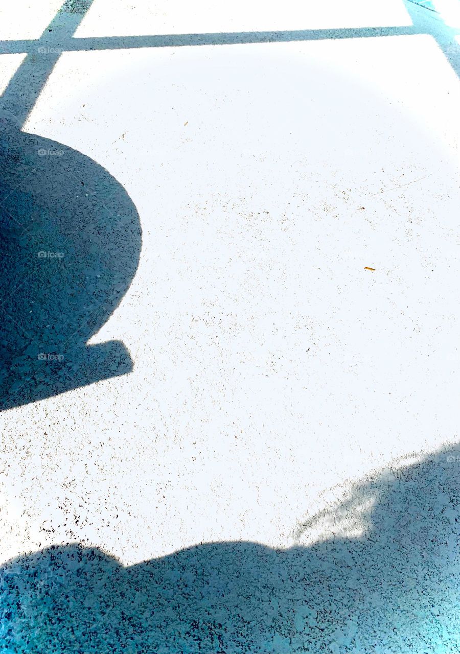 Light And Shadows Of Hanging Out On The Concrete By The Porch At The Beginning Of Sunset.