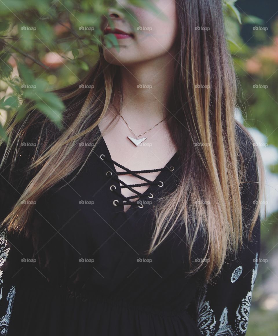 Young girl with face hidden in tree