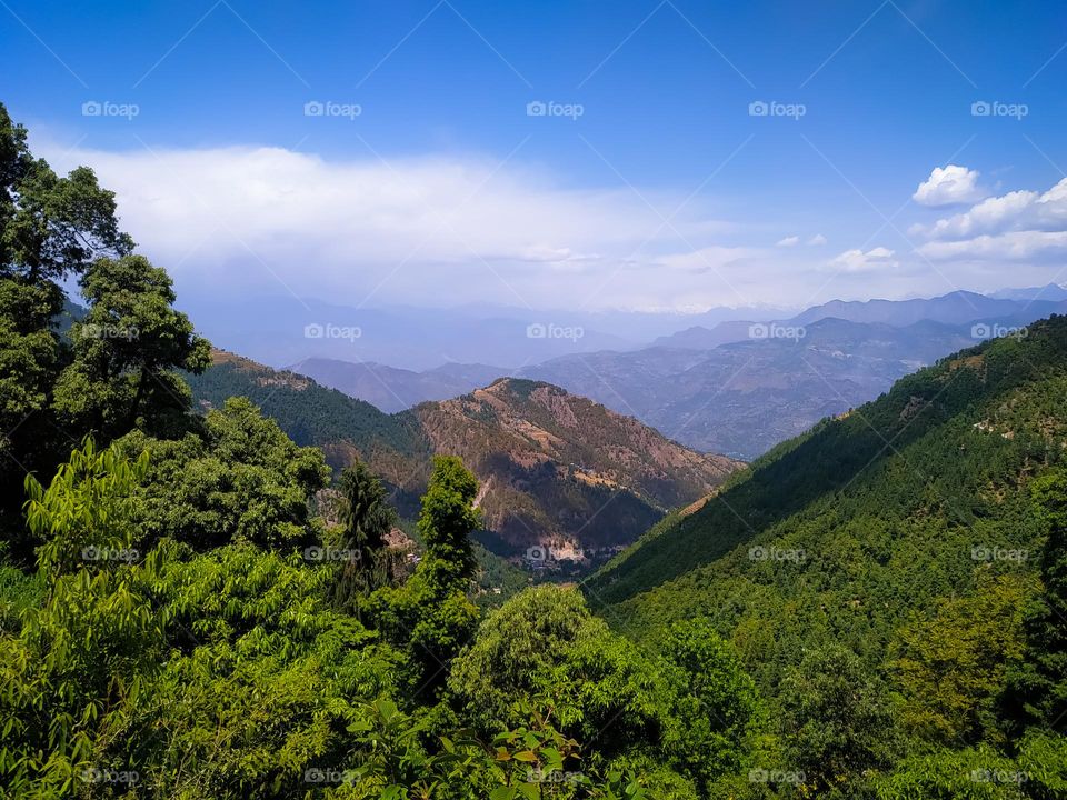 A amazing view of the mountains from above with sky and clouds