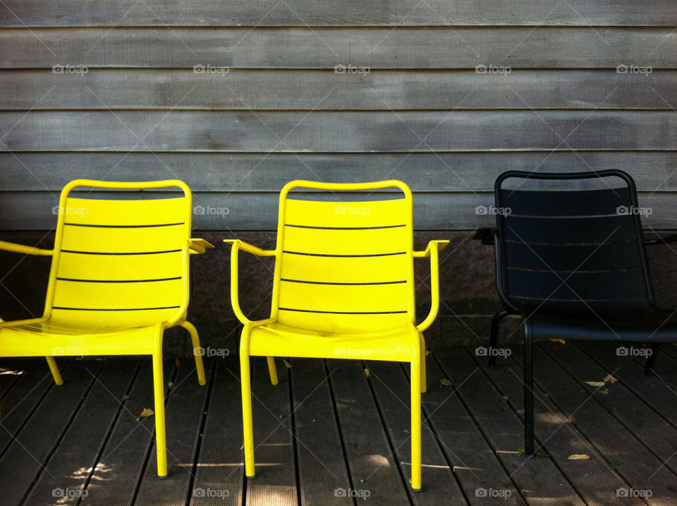 Two yellow chairs and one black chair  
