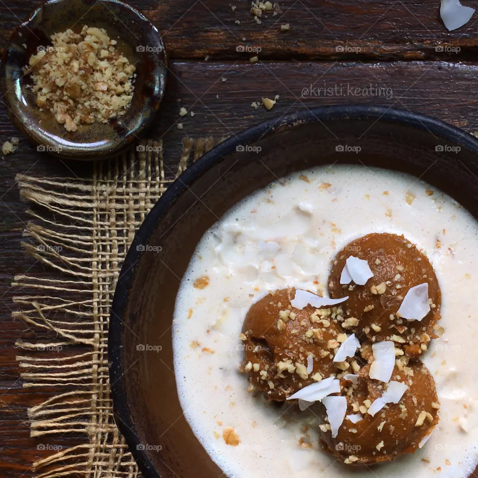 Sweet potato custard with fresh almond milk, crushed walnuts and coconut flakes