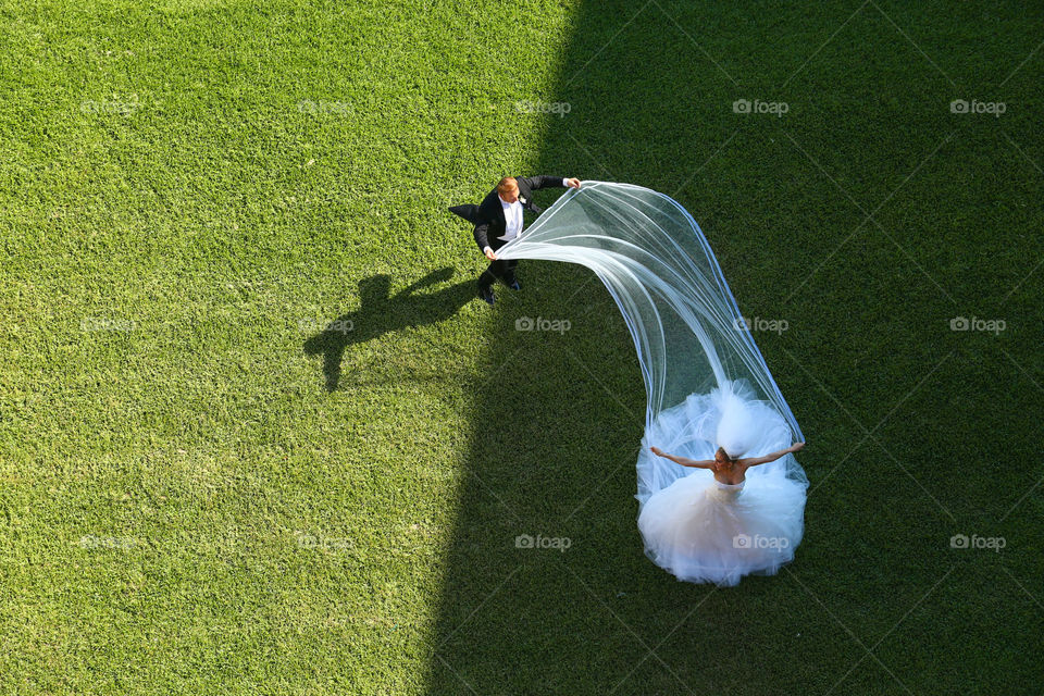 Bride and groom. Wind plays with bride's veil