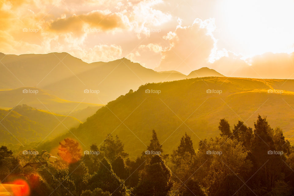 Beautiful scenic sunset over valleys and mountains with golden clouds. Such a beautiful 2019 landscape memory from Drakensberg South Africa