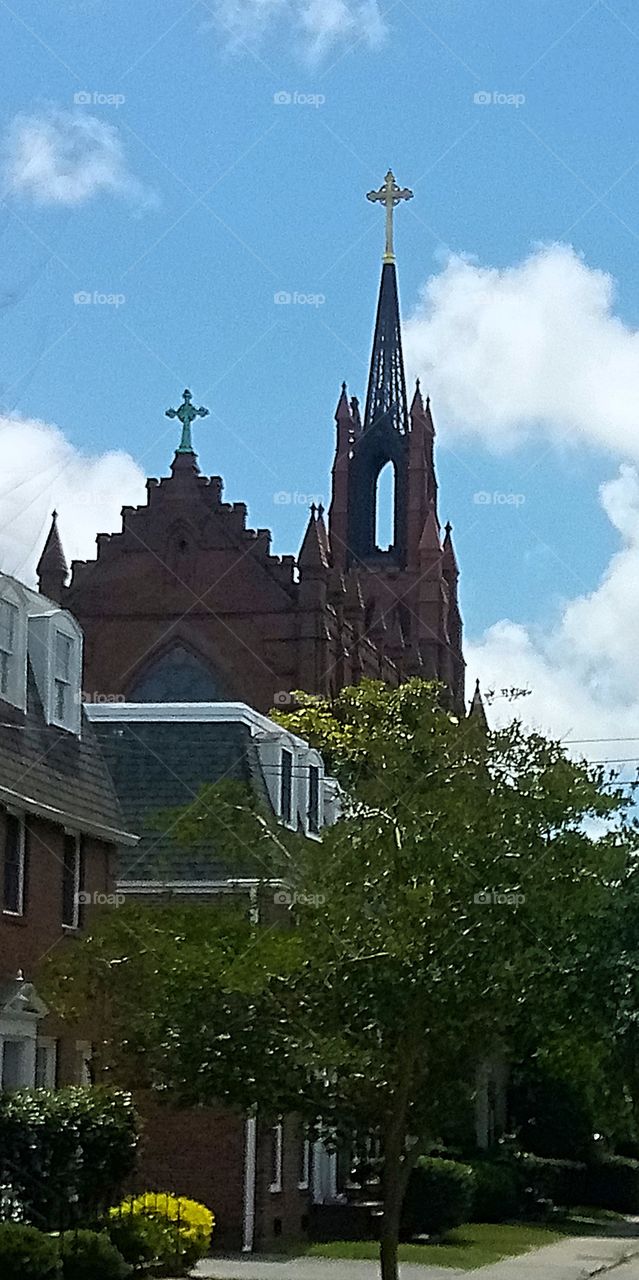 St. John pearing over the neighboring houses