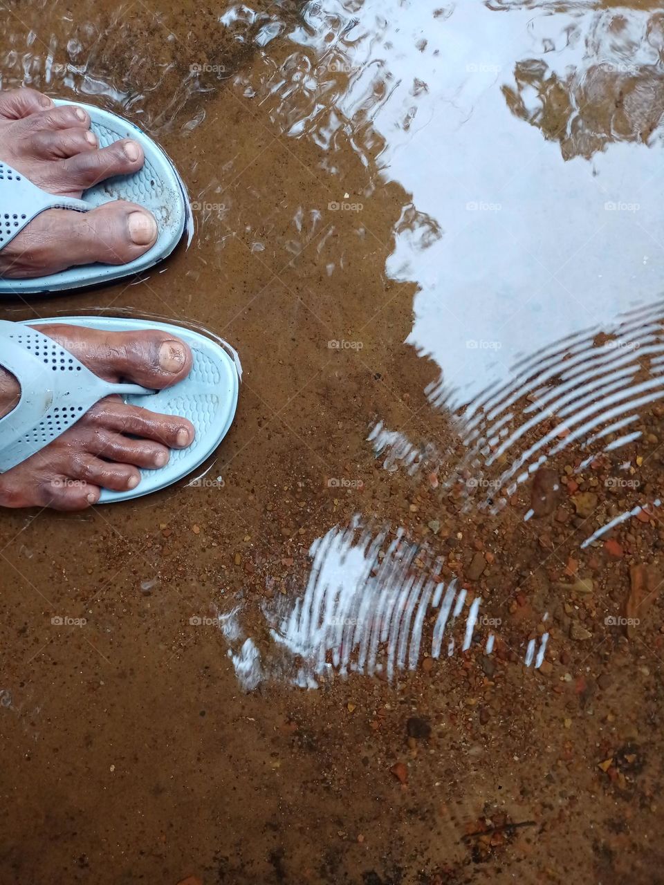 A man has slippers in the rain water beautiful water drop pettern clousup photo