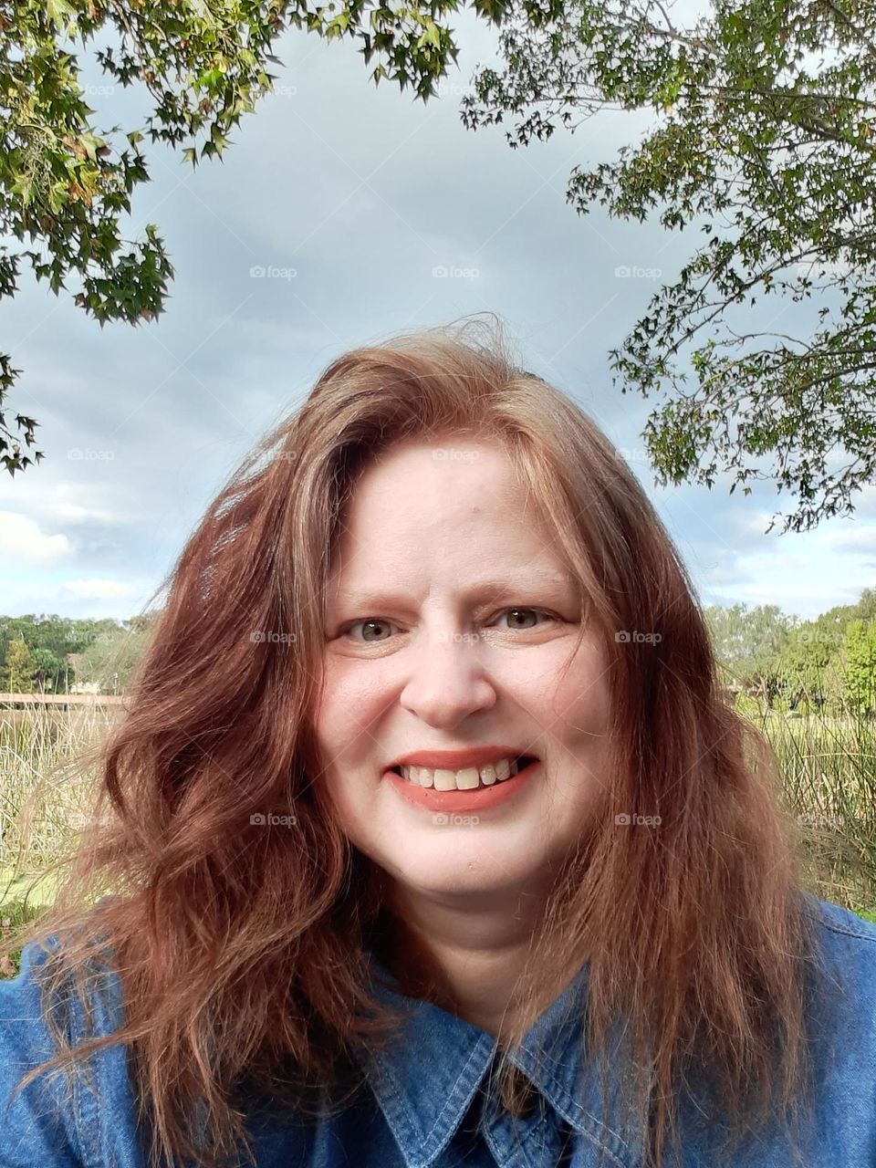 One of my favorite parks to go to is Lake Lily Park in Maitland, Florida. I love to walk around and take pictures there. I took this selfie in front of the lake.