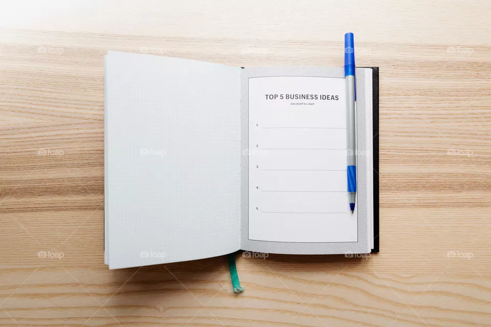 Open Journal With Top Five Business Ideas Photo

An open notebook with a blank page titled Top 5 Business Ideas, a pen sits on top waiting to get to work.