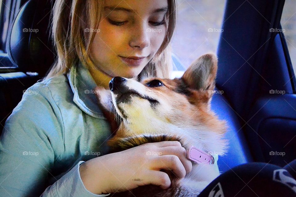 Girl cuddle with her puppy