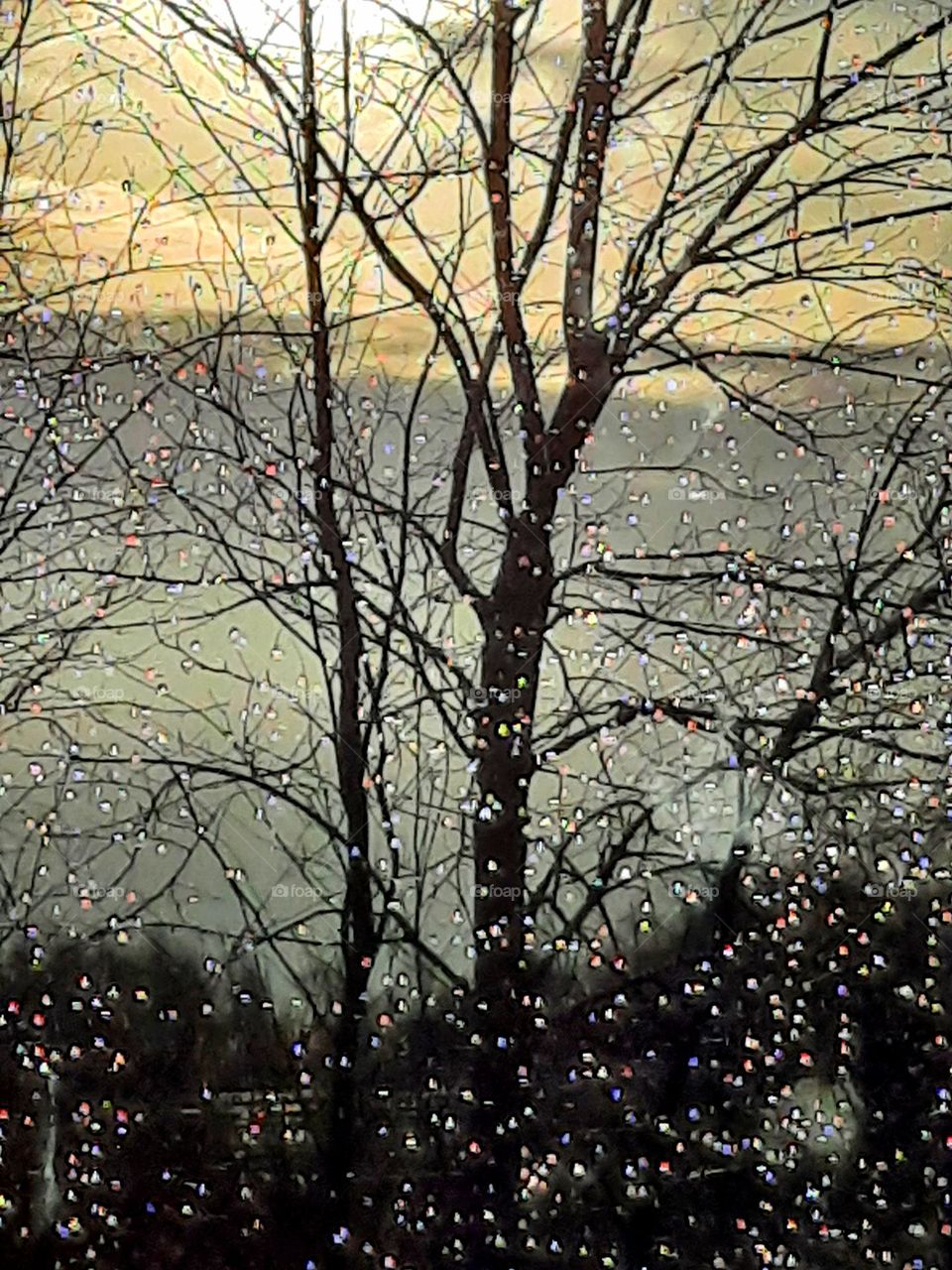 window vue with rainbow in raindrops