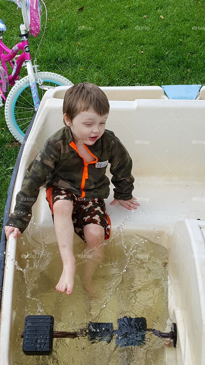 splashing  rainwater in the paddle boat