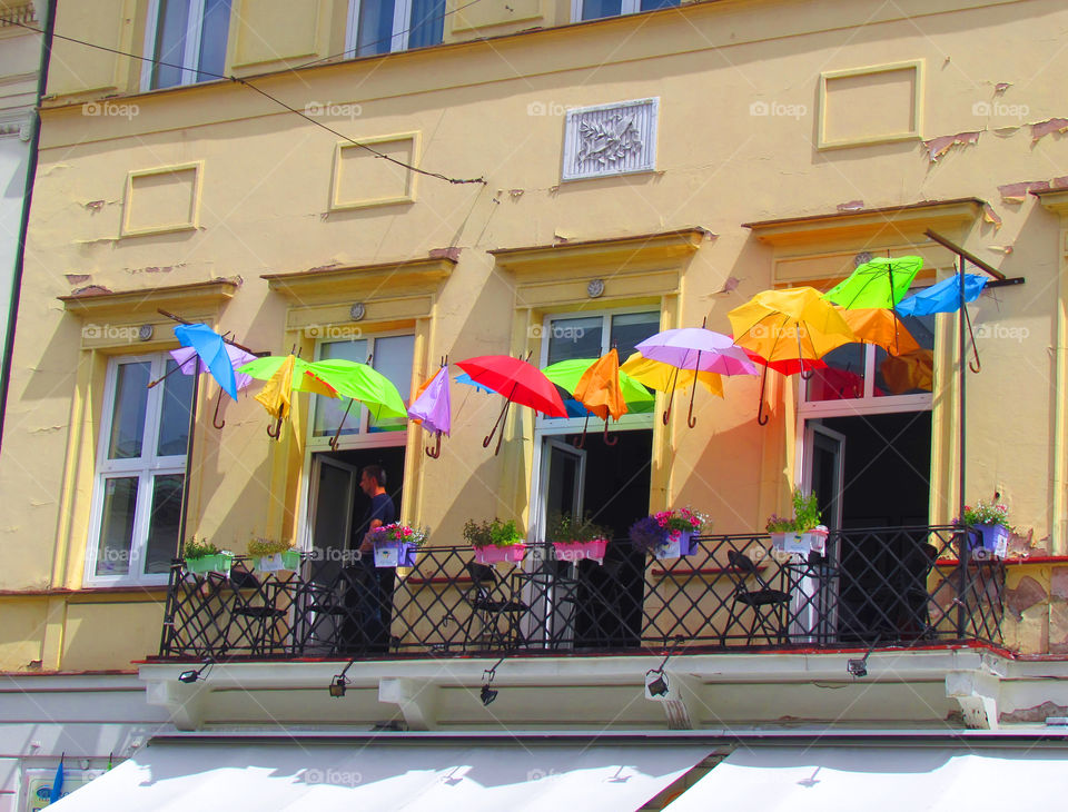 Colorful umbrellas on the facade of the building 