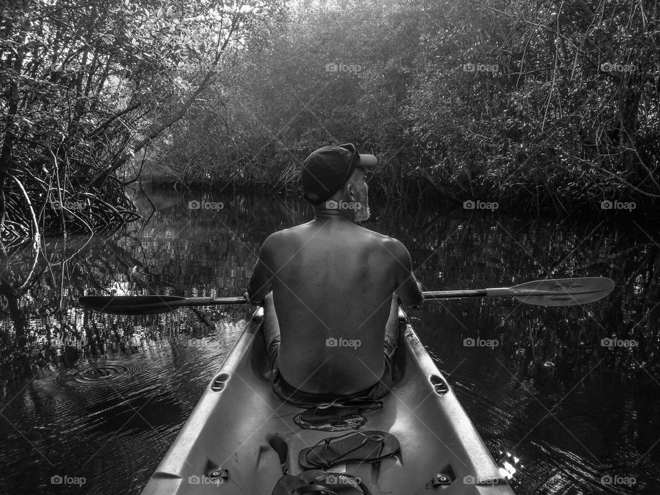 man canoeing in mangrove forest, Koh kood Island Thailand