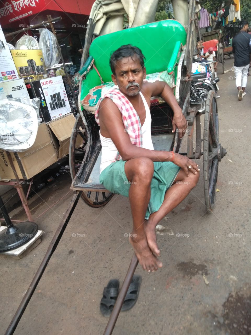 A Riksha puller is waiting for passenger in Chandni Chawk, on a Kolkata afternoon