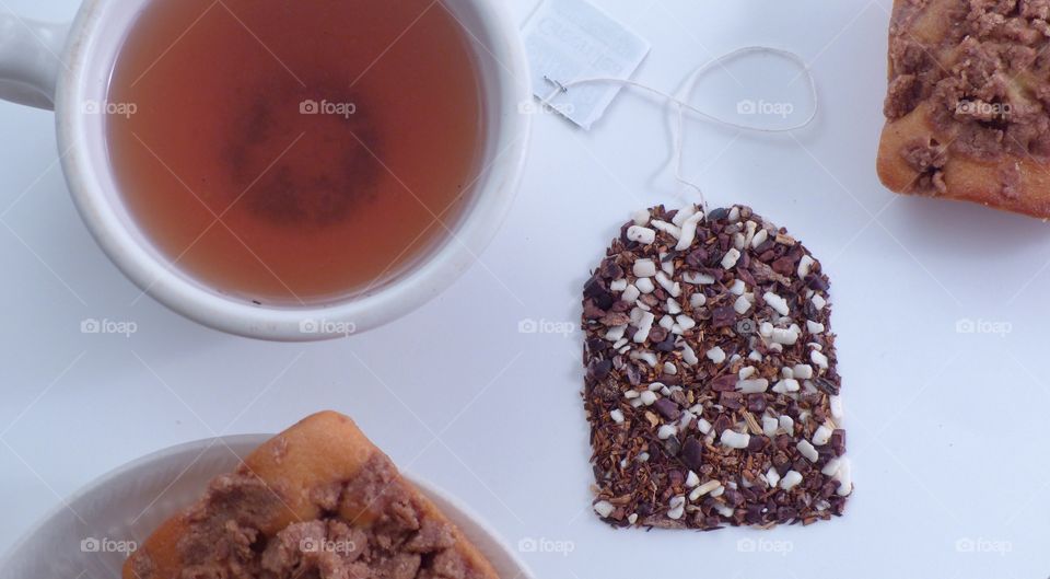 Tea with small cakes and tea bag