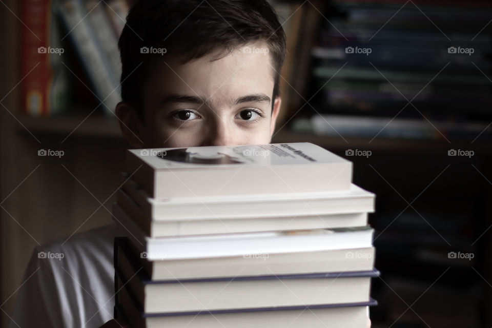 Child with stack of books.
