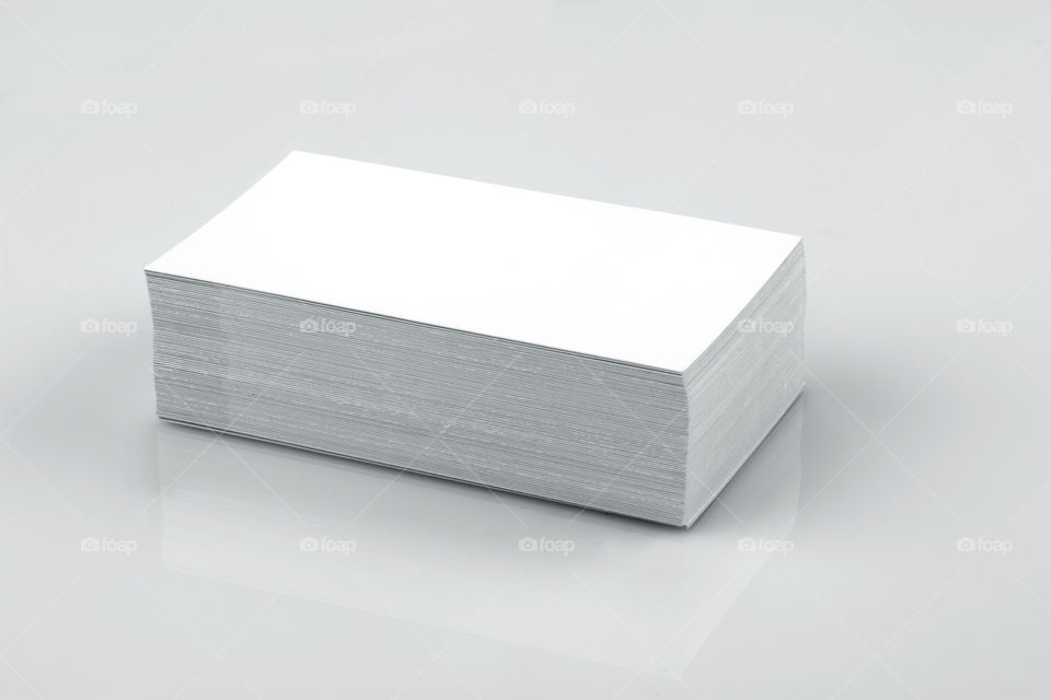 Stack of white business cards on white background