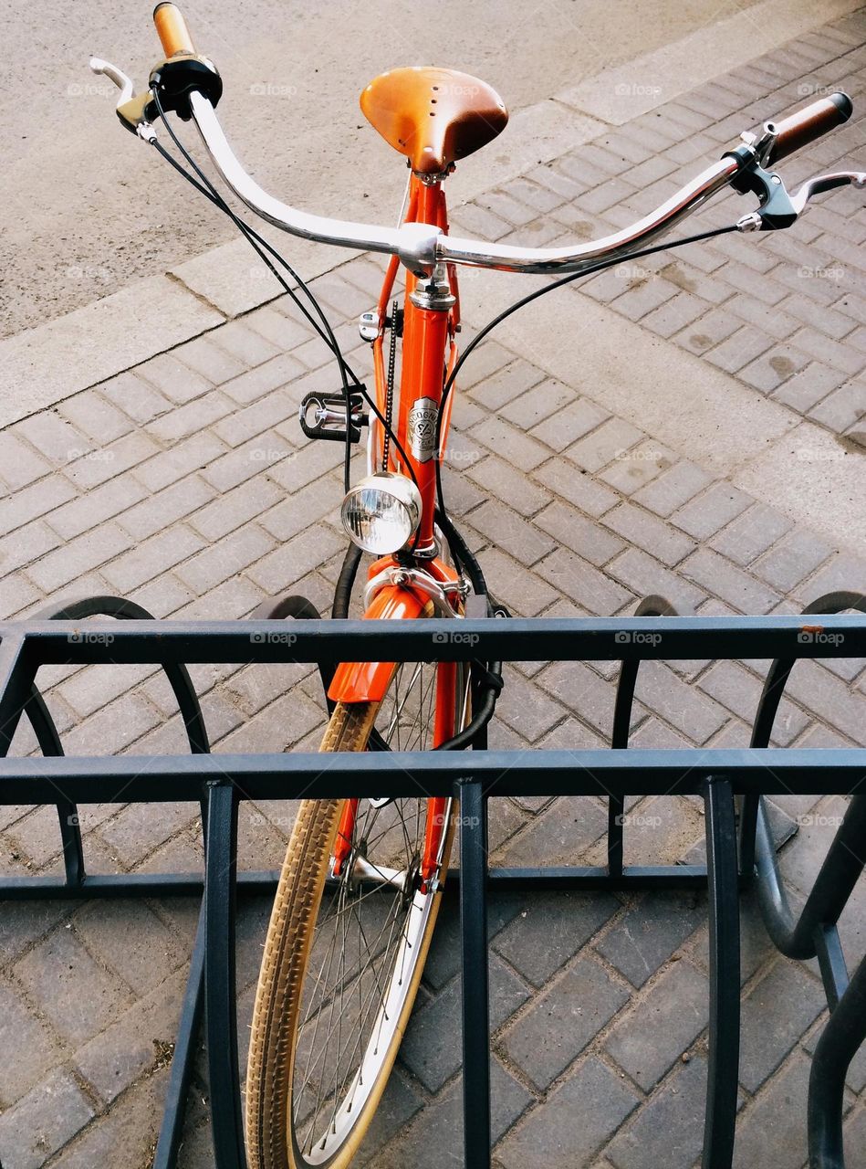 One lonely orange bicycle 