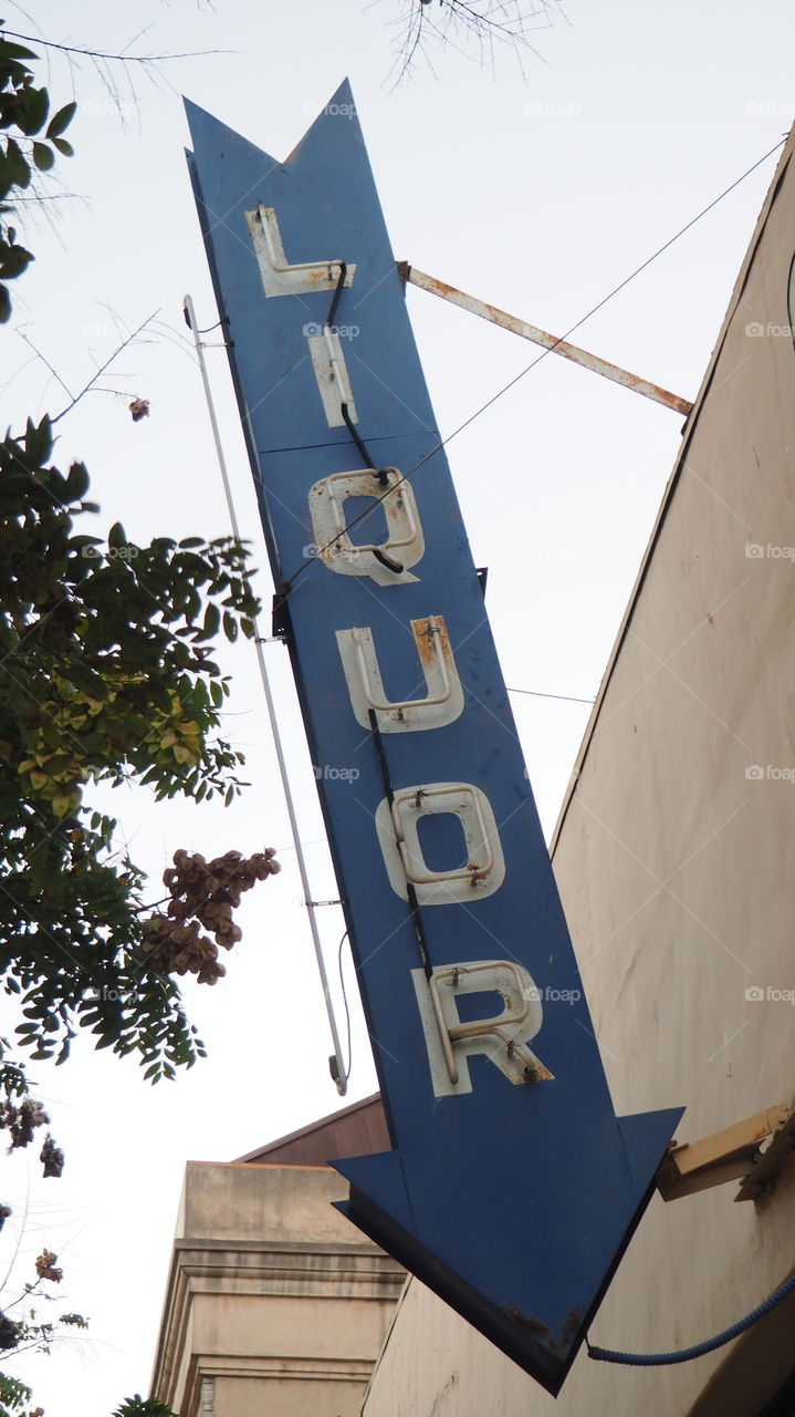 Vintage liquor neon sign. Street sidewalk urban neon sign booze alcohol