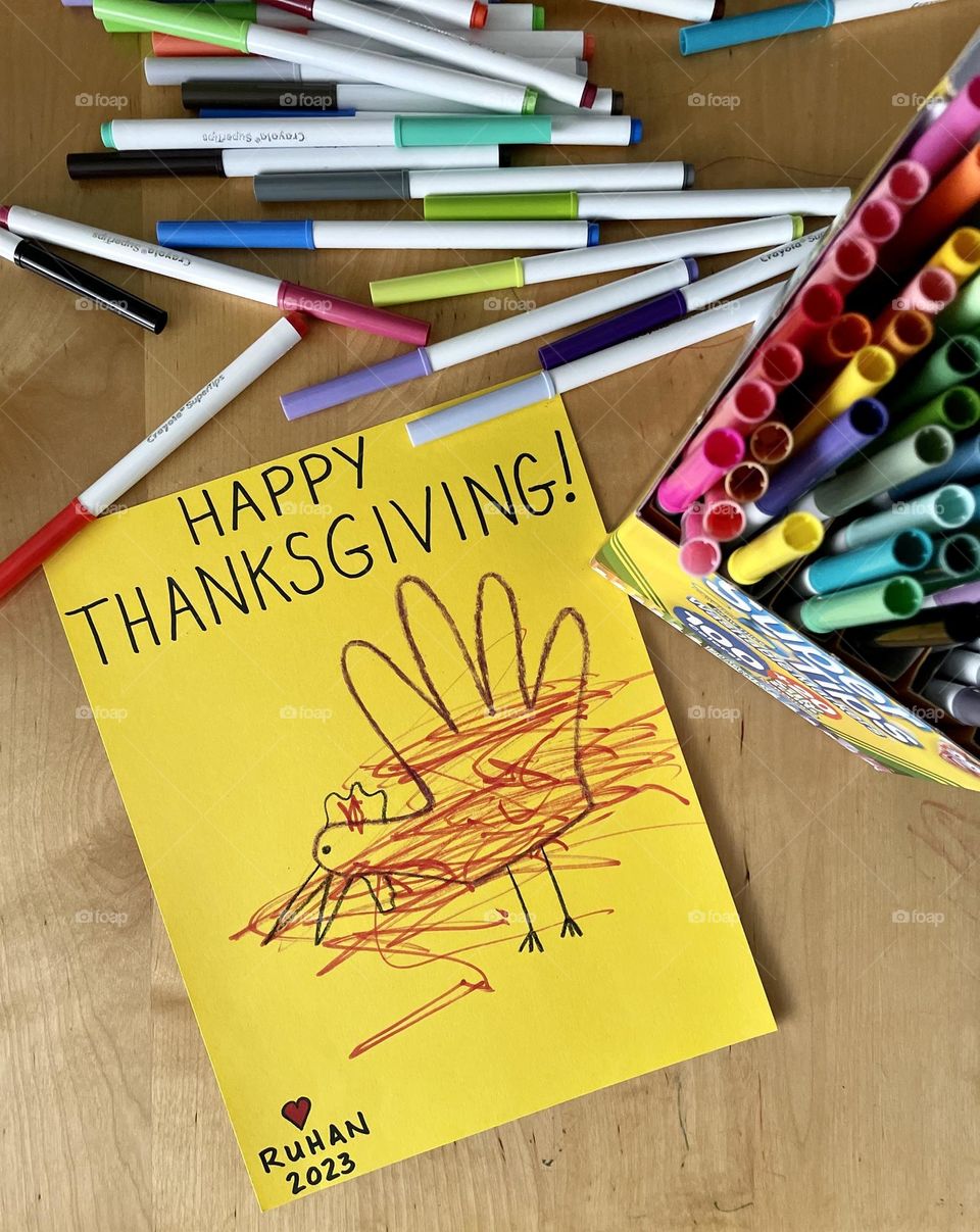 Toddler draws happy thanksgiving turkey, toddler decorates hand turkey, making holiday decorations with children, drawing with toddlers