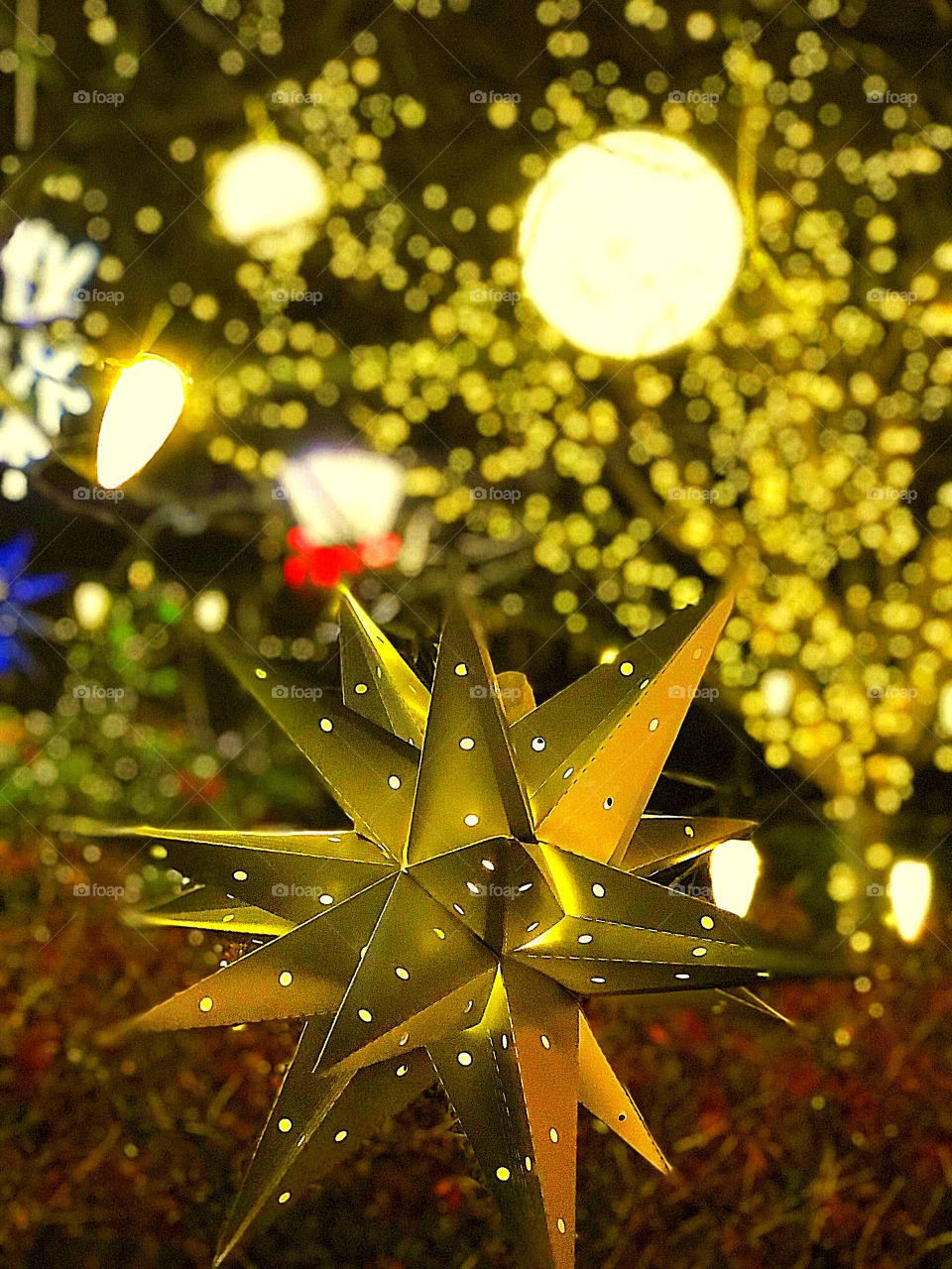 Christmas ornament star amidst lights 