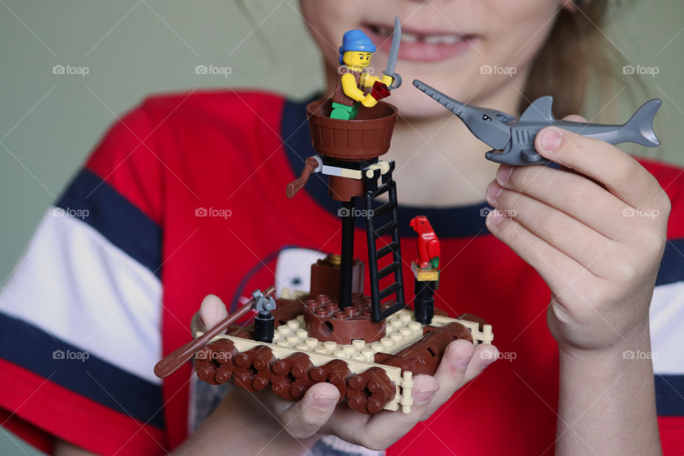 Child playing with Lego Pirates