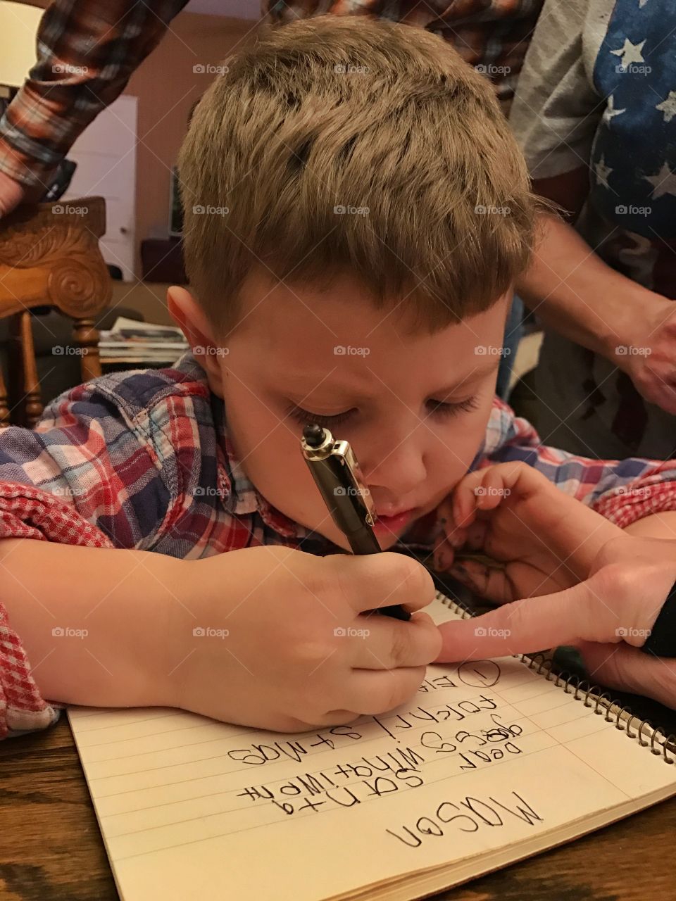 Boy writing on paper