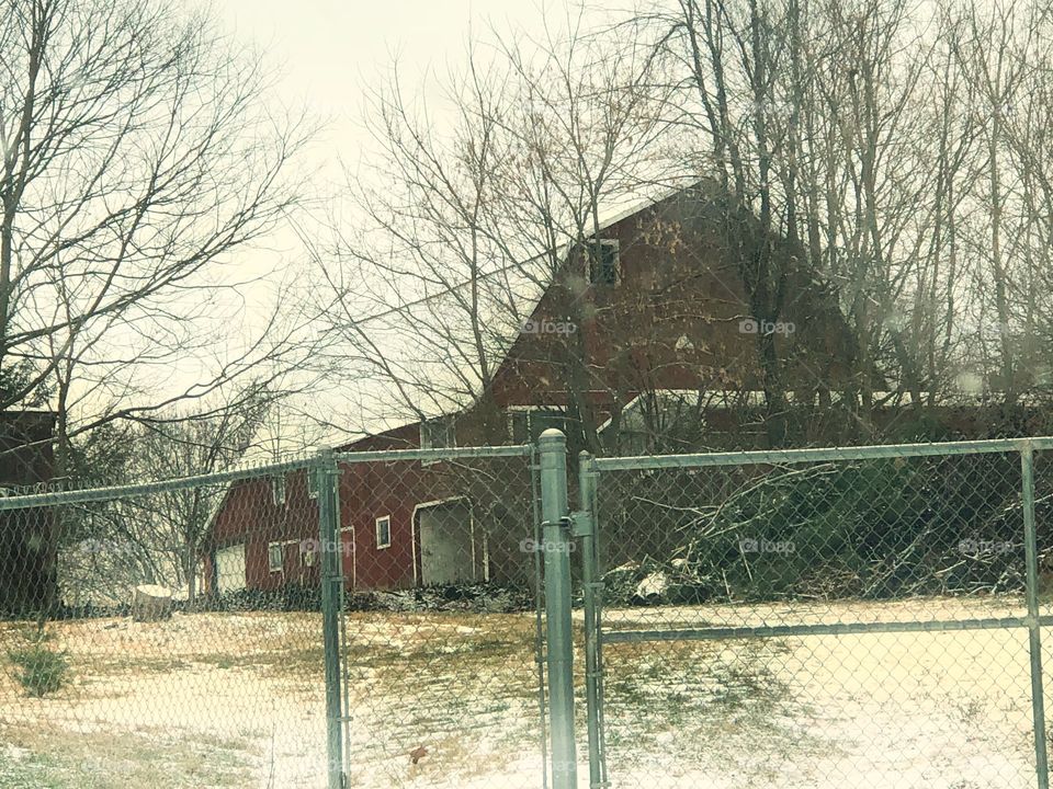 Barn behind chain link fence