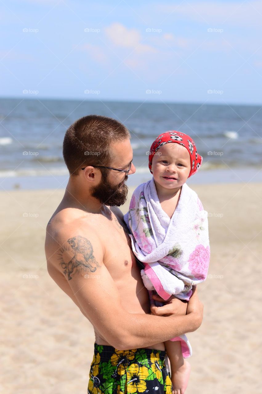 father and son engoying hot summer day on the beach