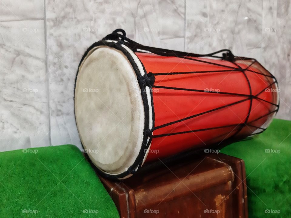 A mini red drum as one of musical instruments