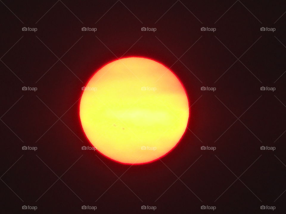 Red Ringed Yekkow Sun. zoomed shot of the sun in a smokey haze