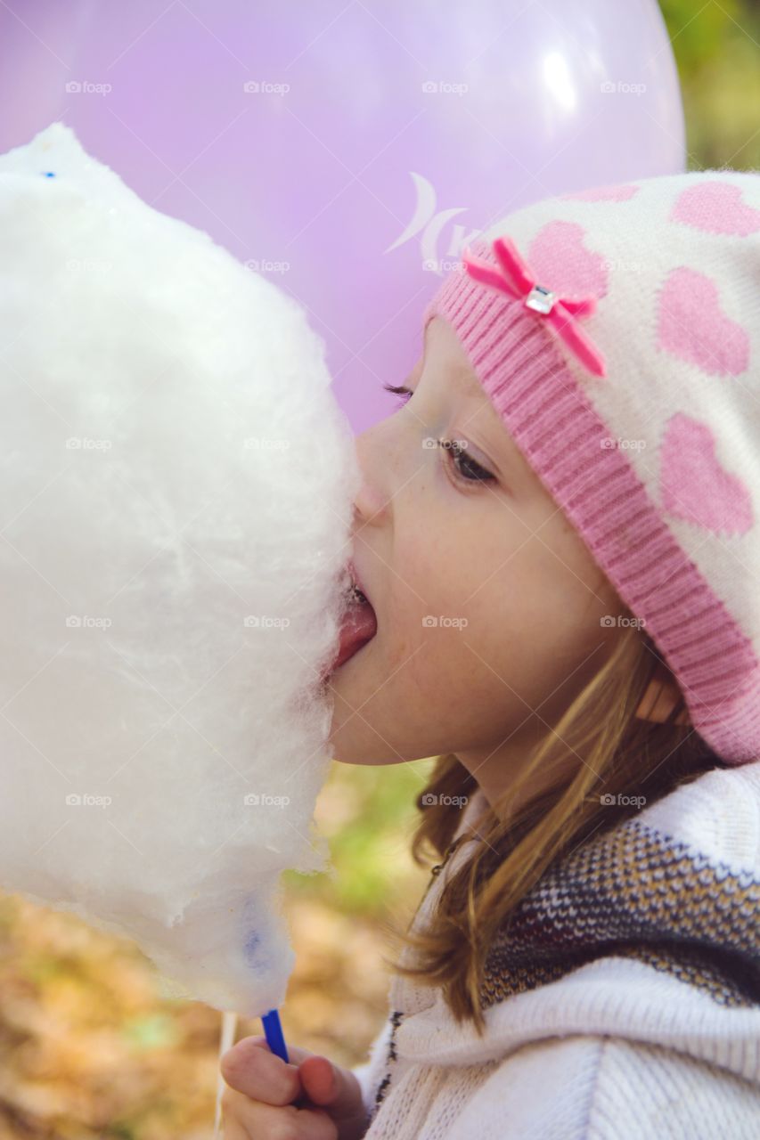 Girl eating cotton candy