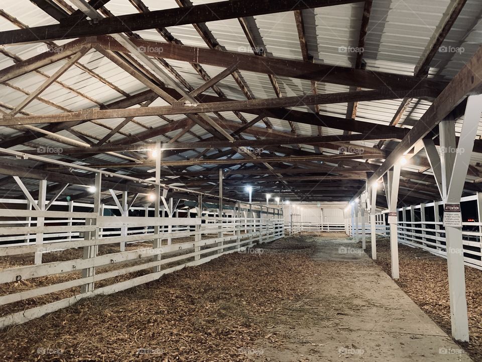 Empty stalls of an open-air barn for cattle before being shown in competition at a county fair