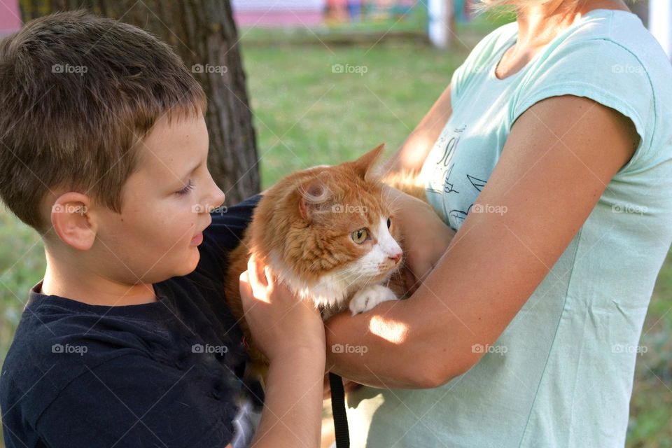 family with cat outdoor happiness