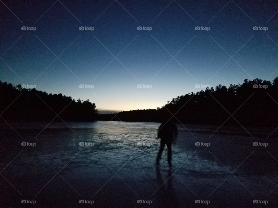 Night bright sky shinning down on the frozen lake