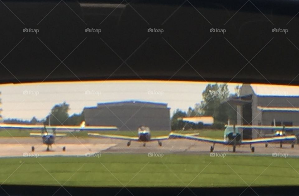 Small planes on the RAMP, pictured through my rear view mirror. 
Ledgedale Airport
Sweden NY