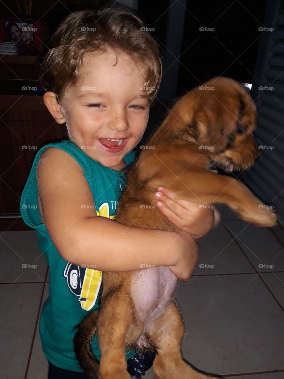 beautiful child playing with the happy dog
