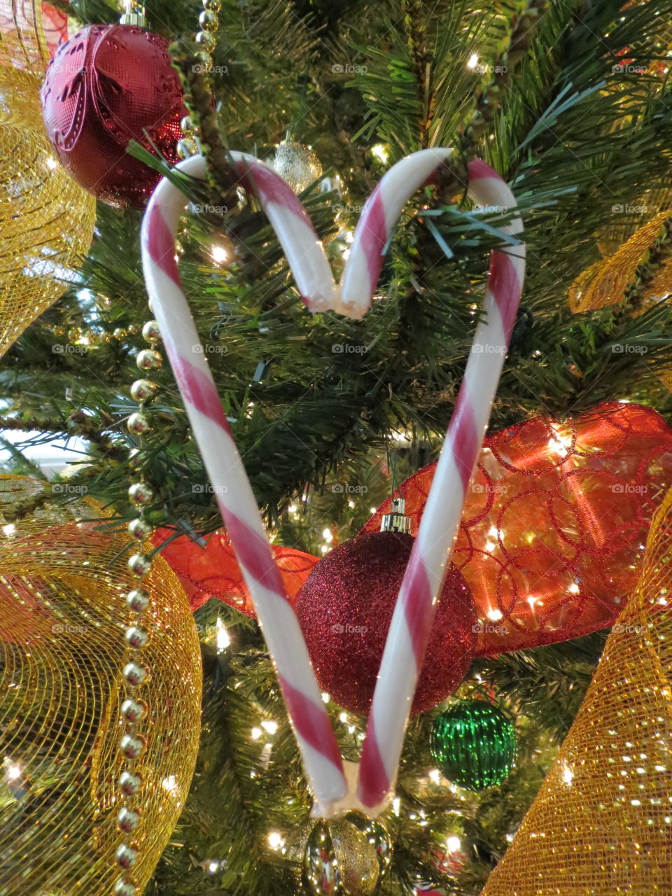 Candy cane heart hanging on the Christmas tree.