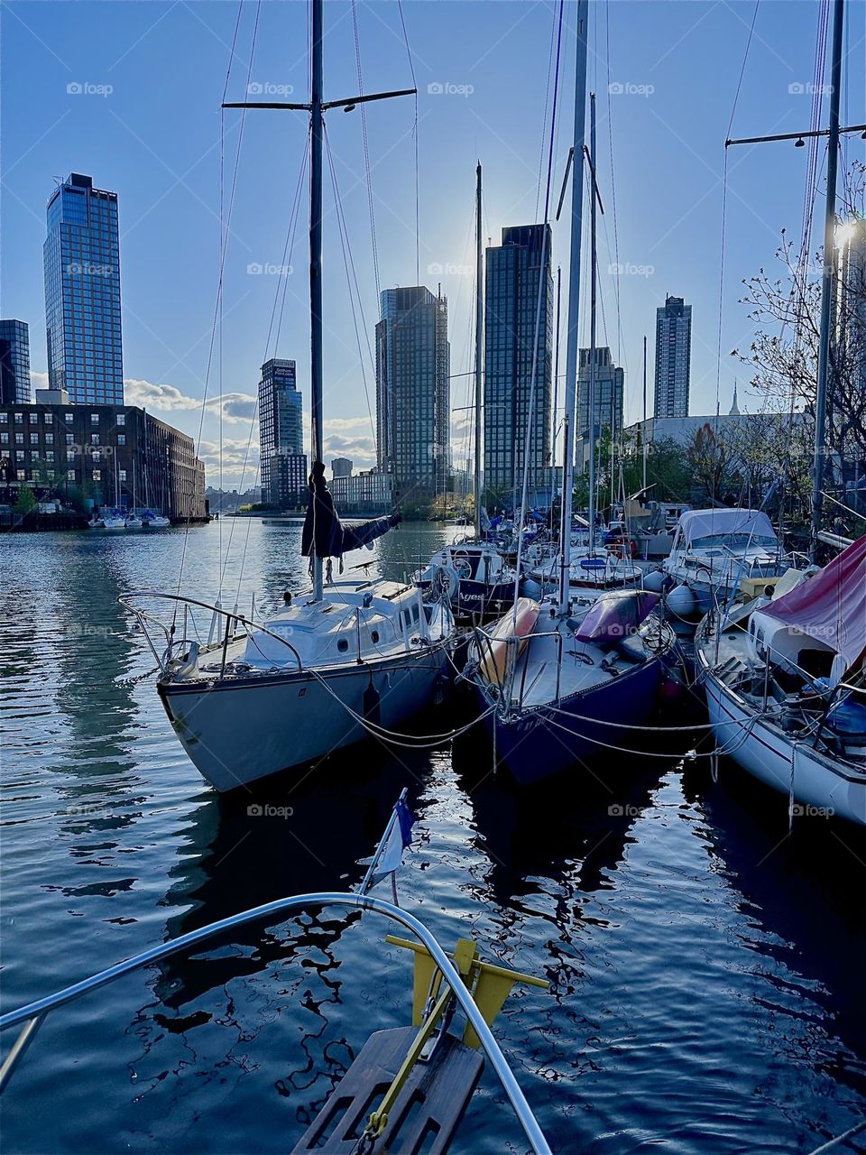 This is beautiful „Newtown Creek“ by the „Pulaski Bridge“ in LIC, Queens with various boats that are tied to the shore here. Across the „East River“ you see „Greenpoint“, Bklyn then LIC and „Manhattan“. 2024. Hypnotic Productions