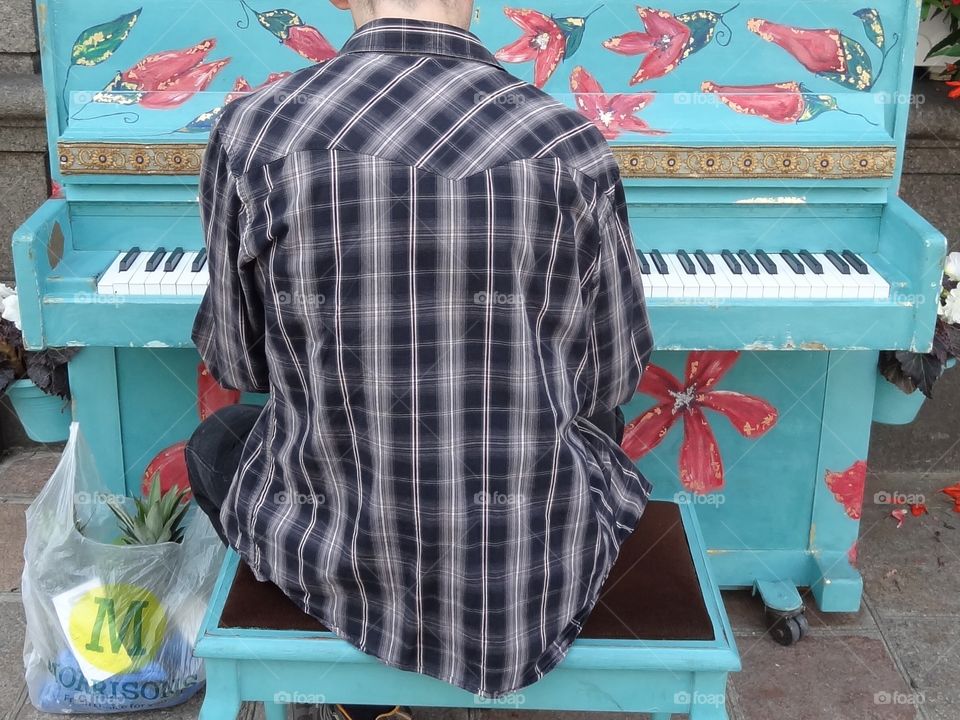 The Pianist. Colourful pianos dotted about for anyone to play