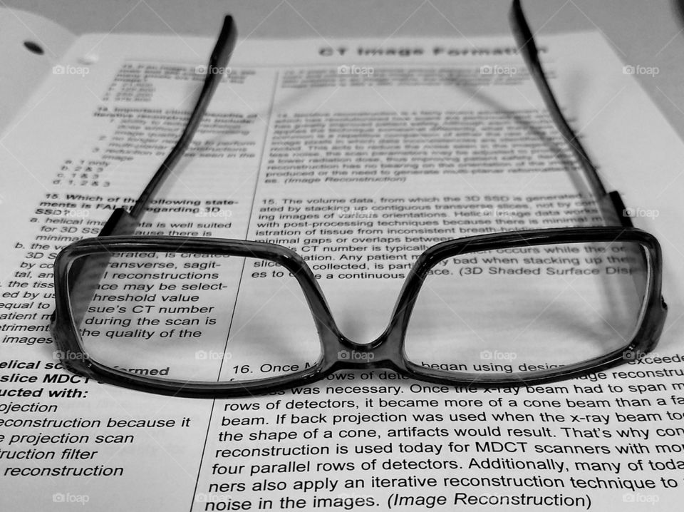 Reading glasses on a book page.