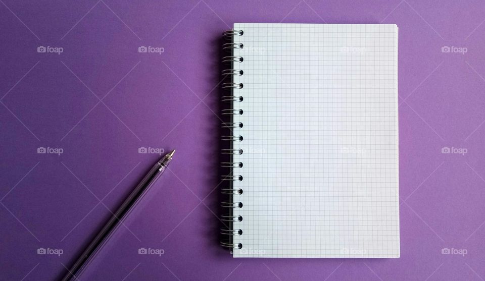 White paper notebook on violet background
