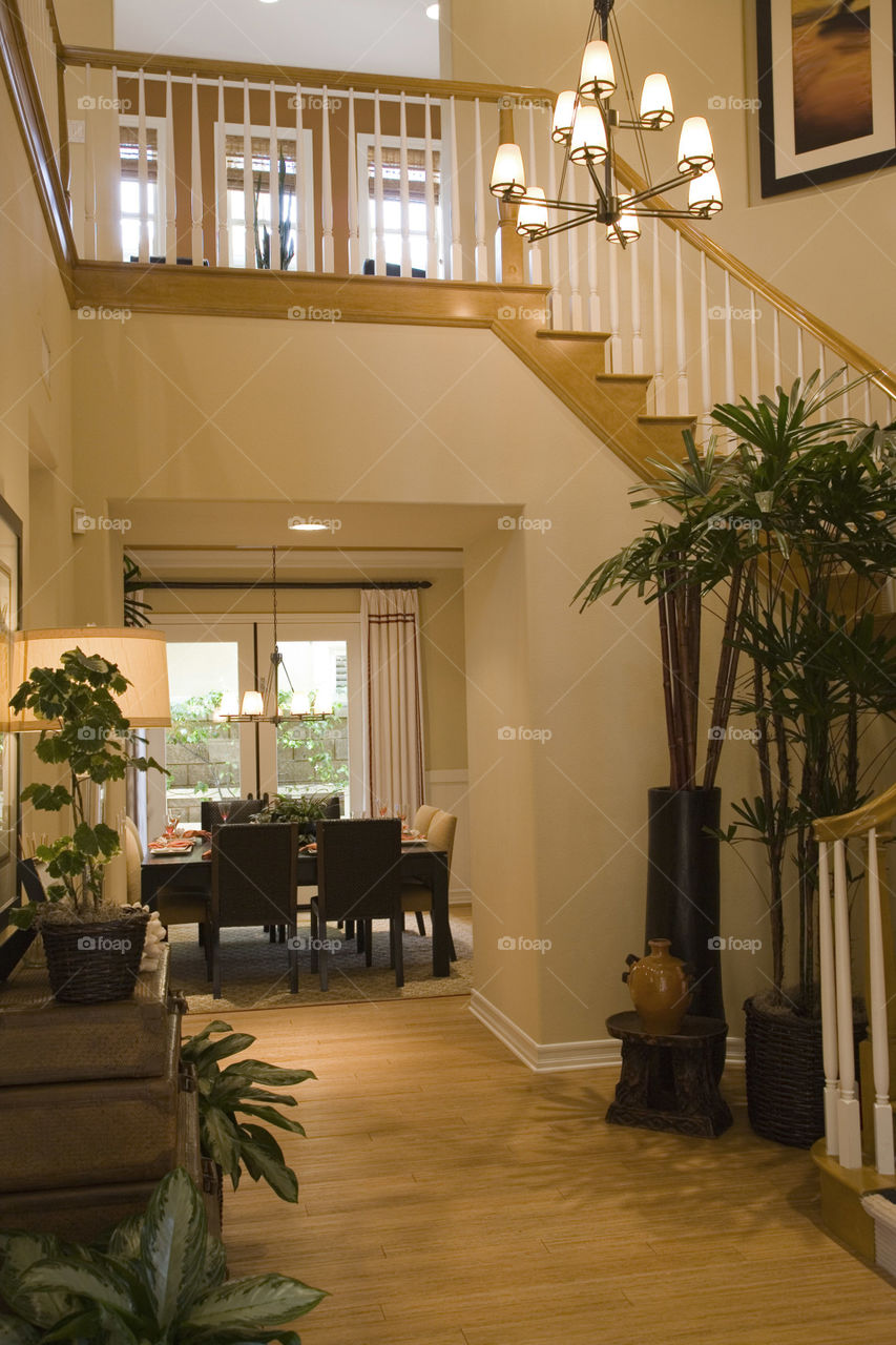 Vaulted ceilings of showhome, modern decor, bright room and majestic staircase.