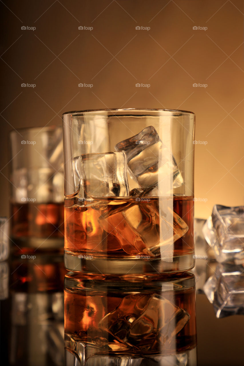Two whiskey glasses with ice cubes