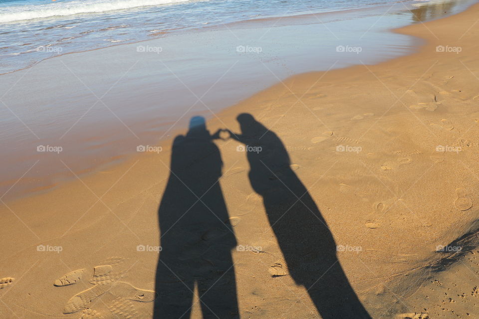 Shadow of a couple on the beach 