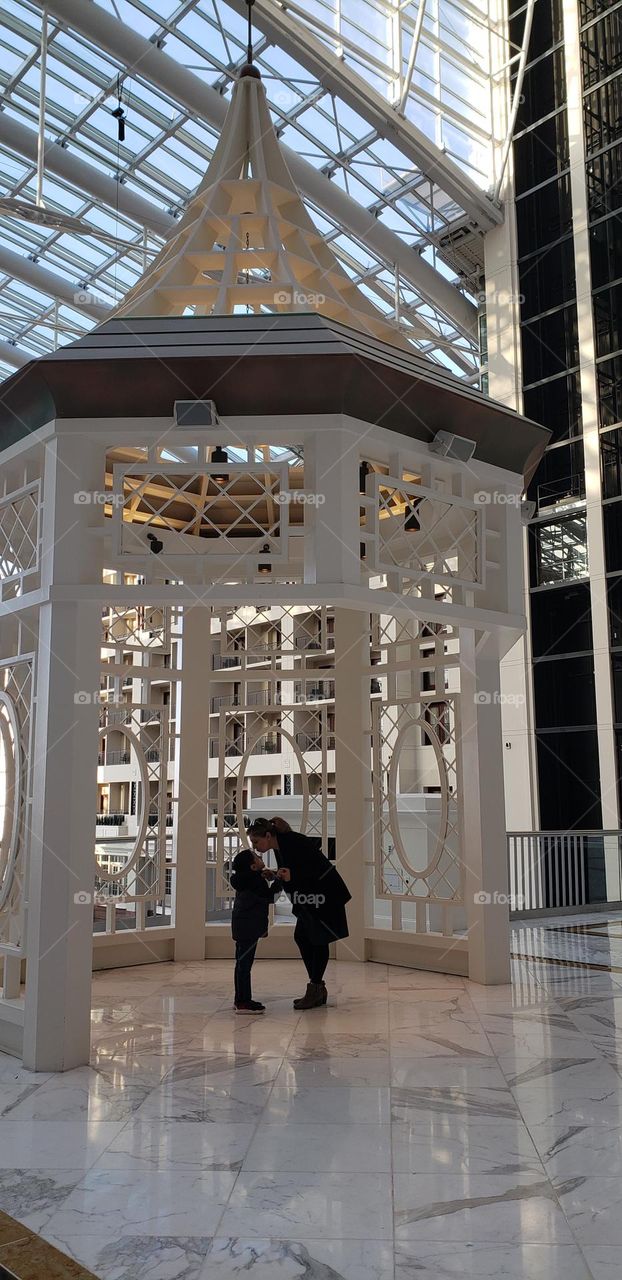 A mother an son kissing under a gazebo