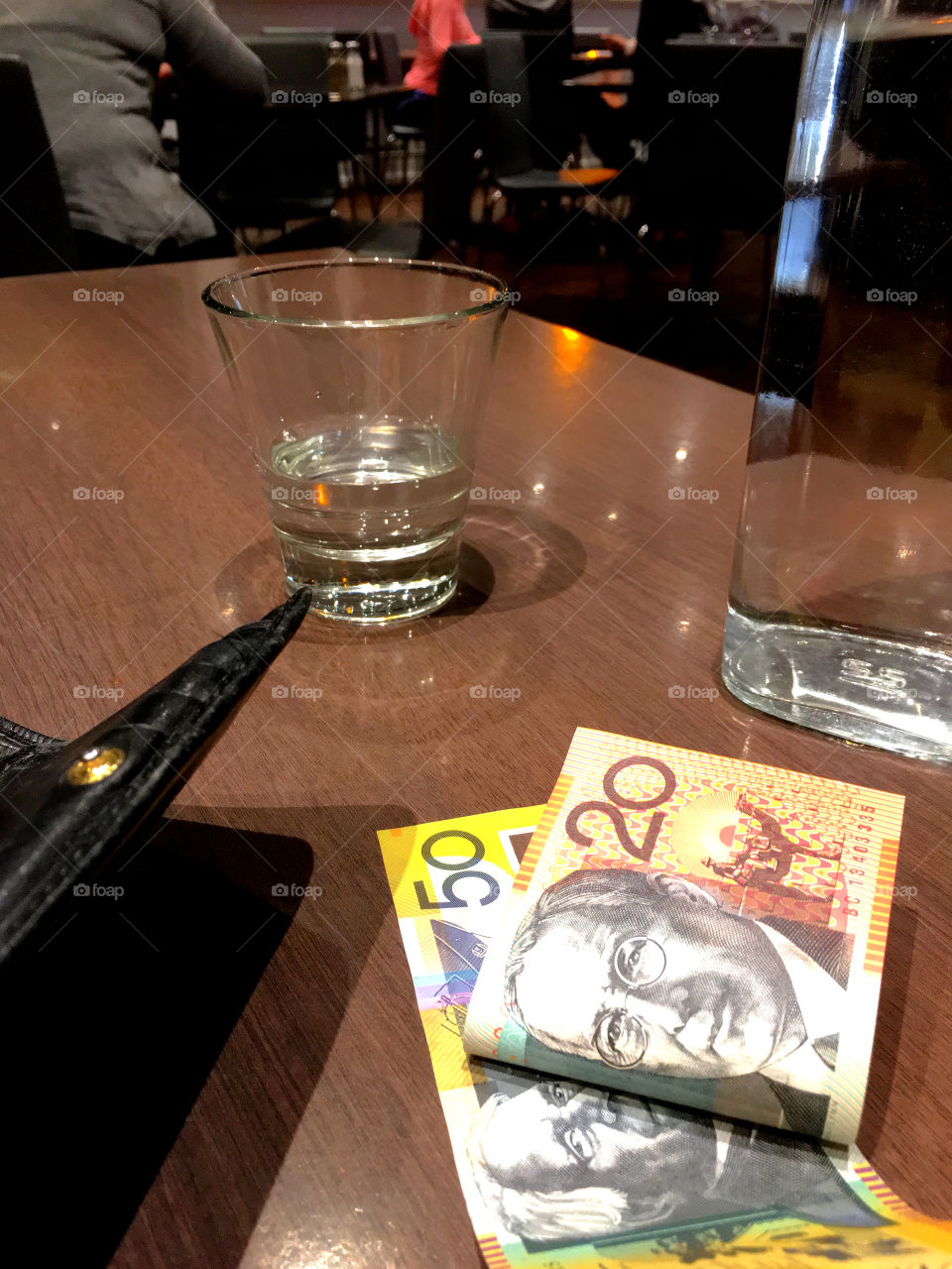 Paying a restaurant bill in Australian restaurant, Australian currency, wallet, credit cards