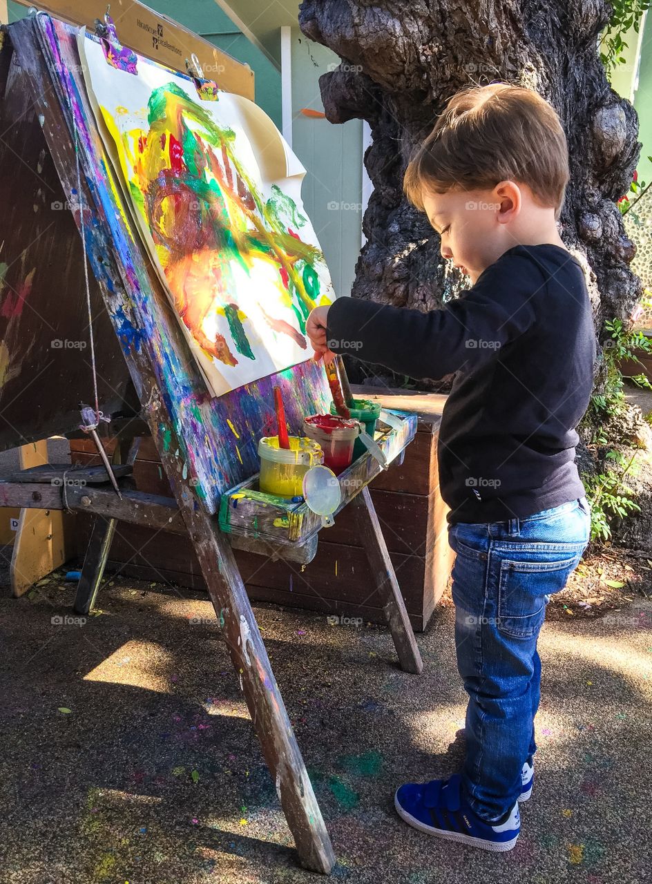 Cute little boy painting