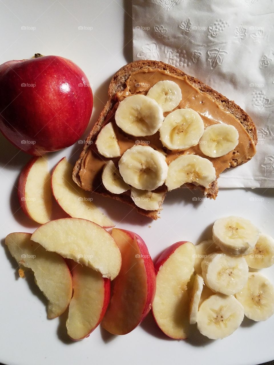 Bread with peanut butter and fruit slices
