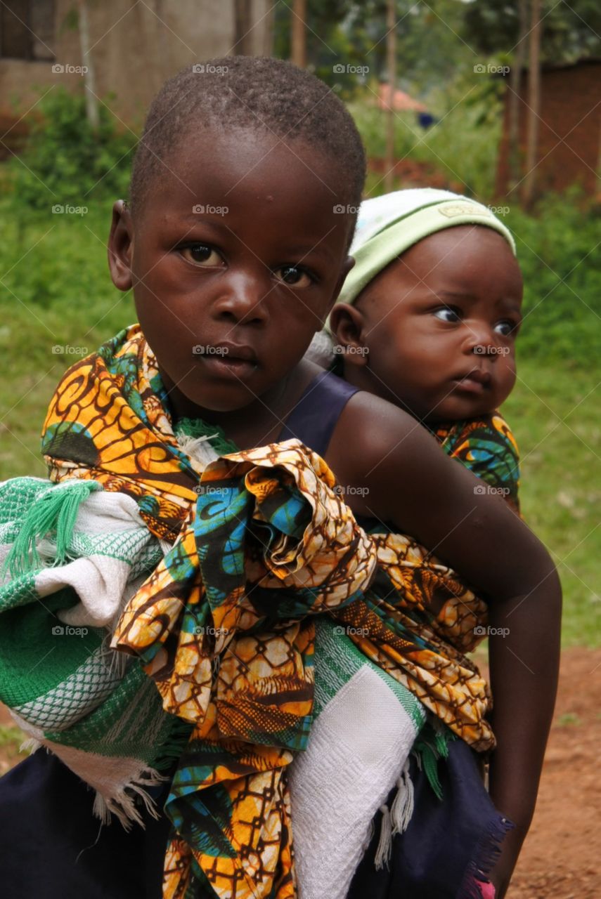 Little Mama . Children are expected to care for younger siblings in Africa.